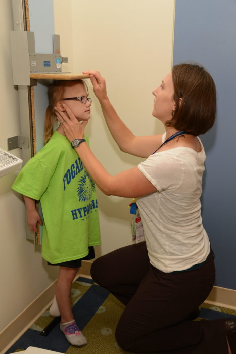 A girl with Goltz syndrome is measured as part of the 2015 Goltz Conference.