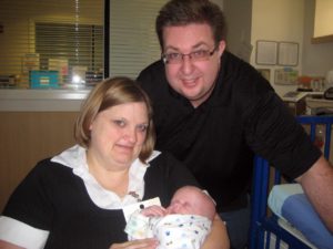 New parents hold their infant son who is affected by HED.