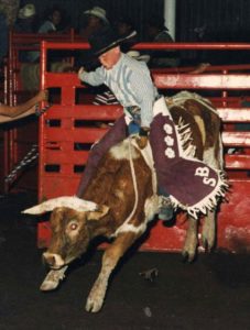 Cody rides a bull.