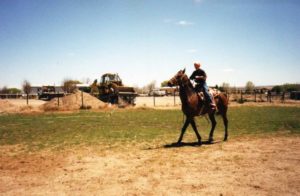 Cody rides a horse in New Mexico heat.