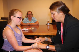 Christyn and Jana Luallen with a hand surgeon