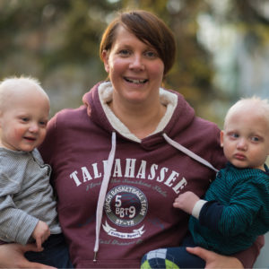 Mom holds twin boys affected by x-linked hypohidrotic ectodermal dysplasias who were treated in utero and developed working sweat glands.
