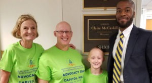 Mary Fete, Virginia Higgins and son meet with an aide from Senator Claire McCaskill's office.