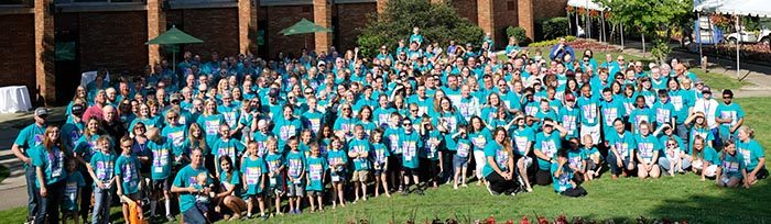 Family conference attendees standing in front of the hotel.