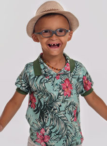 Child smiling in Hawaiian shirt