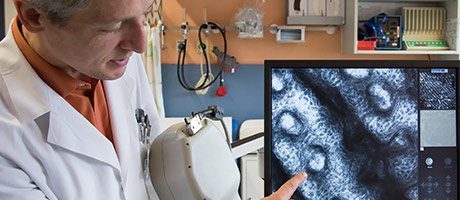 Researcher showing information on a screen