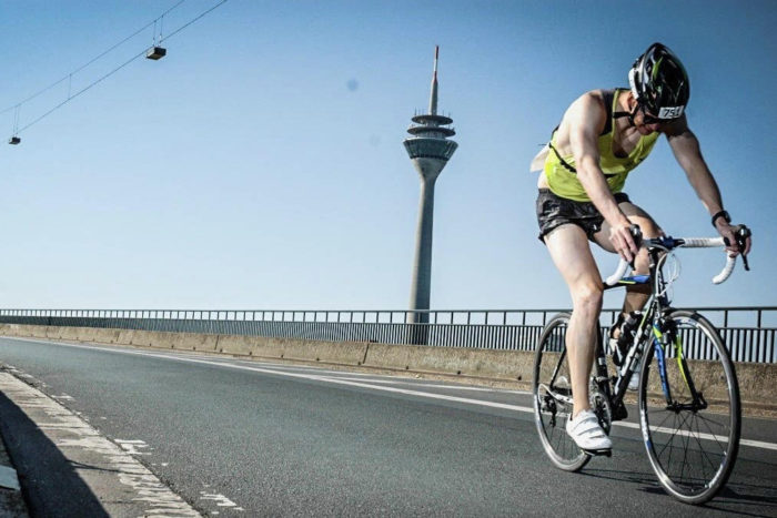 Markus Kappen sits on his bike and looks down at the road during a race.