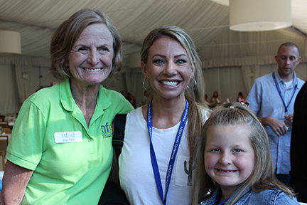 Mary Fete stands arm and arm with a mom and her daughter, who is affected by ectodermal dysplasia at an NFED Family Conference.