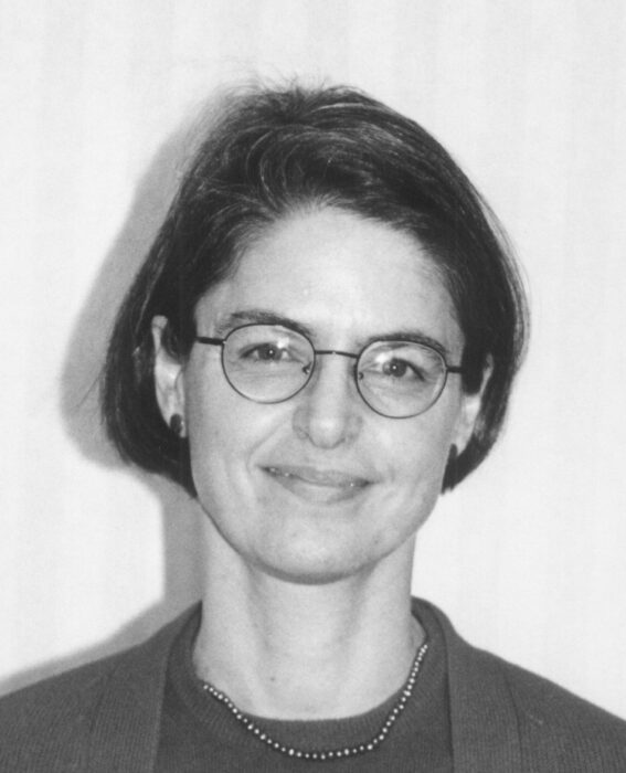 This is a head shot of Dr, Siegfried. She has short, dark hair and is wearing glasses.