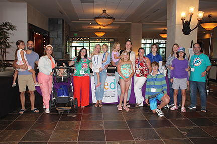 This is a group of families standing in a hotel lobby.