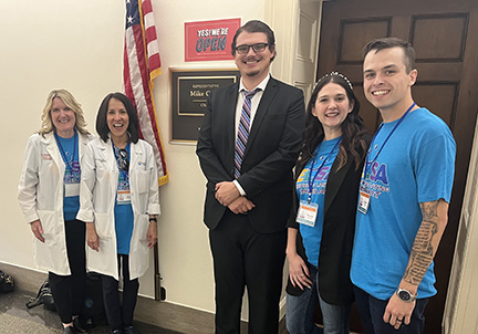 Two female dentists and two other ELSA advocates pose with a staffer from a  legislative office.