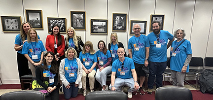 A large group of advocates from New York meet with their legislator.
